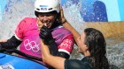 Jessica Fox leaps into the water to celebrate with her sister Noemie.