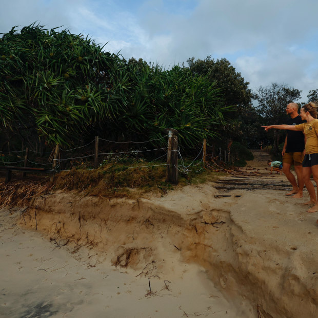 Byron locals Julia Spicer with partner James Harvey and son Kitt, 9, check out the erosion at Tallow Beach Suffolk Park.