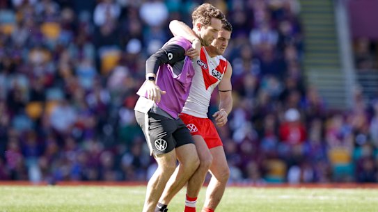 Tom Papley is helped from the Gabba after suffering an ankle injury last Sunday.
