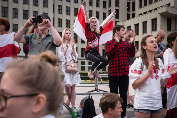 Protesters wave the traditional Belarusian flag on August 18 in Minsk. 