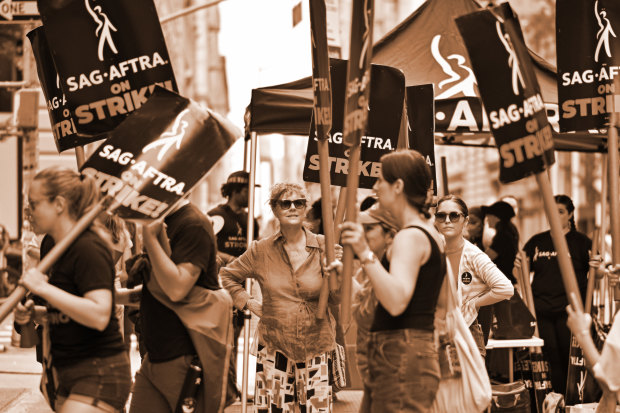 Actor Susan Sarandon, centre, joins a picket line outside the offices of Netflix and Warner Bros in New York City on July 19.