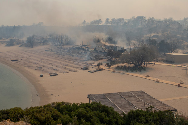 A wildfire burns next to a beach near Lindos, on the island of Rhodes, Greece.