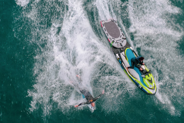 Formston gets ready  to pop up on a wave off Boulder Beach, launched by Michael Crisp from the jet ski. 