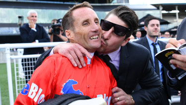 Pucker up: Damien Oliver laughs as he is kissed after his winning run on Seabrook.