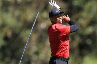 Tiger Woods drops his club after his approach shot on the fifth hole of his final round in the 2022 Masters.