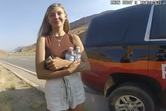 A still taken from a police camera video shows Gabrielle “Gabby” Petito talking to a police officer after the van she was travelling in with her boyfriend Brian Laundrie was pulled over near Arches National Park on August 12, 2021.