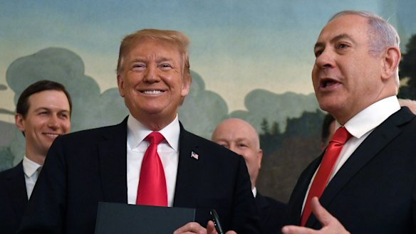 Donald Trump smiles as he holds a proclamation formally recognising Israel's sovereignty over the Golan Heights with Israeli Prime Minister Benjamin Netanyahu.