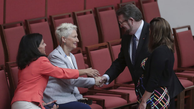Derryn Hinch shakes hands with crossbench MPs Julia Banks and Kerryn Phelps in the Senate on Wednesday.