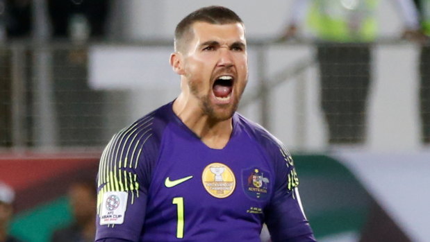 Hear me roar: Mathew Ryan pumps himself up after saving a penalty in Australia's shootout win over Uzbekistan.