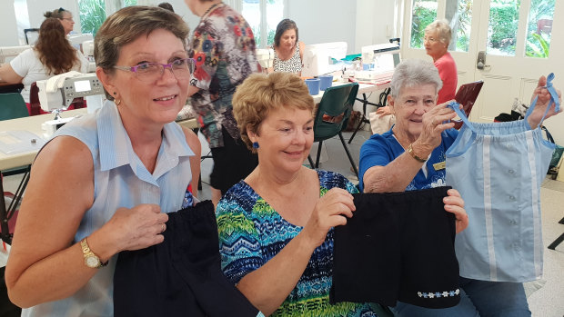 Janelle Downer and the Reef Sisters at the Cairns branch of the Australian Sewing Guild working to create outfits for the Uniforms 4 Kids project.