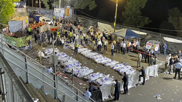 Israeli security officials and rescuers oversee the bodies of victims who died during a stampede at Mount Meron in northern Israel on Friday.