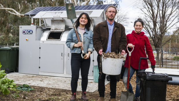 Events and projects manager Gaby Ho, director Ryan Lungu, garden coordinator Karina Bontes next to their new public composter at the Canberra Environment Centre.