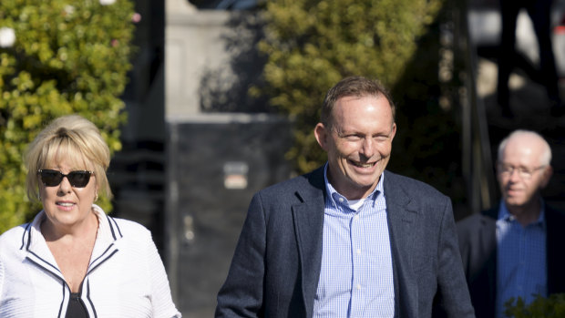 Former prime minister Tony Abbott strolls along the Rose Bay pier with Teena McQueen.