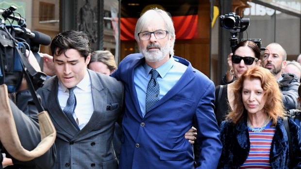John Jarratt (centre) walks from court with his wife and lawyer after he was found not guilty of rape.