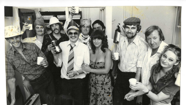 Police rounds Christmas party in the Russell Street pressroom, 1980. SIlvester, wearing an alarmingly wide tie, is in the middle.