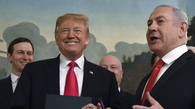 Donald Trump smiles as he holds a proclamation formally recognising Israel's sovereignty over the Golan Heights with Israeli Prime Minister Benjamin Netanyahu.