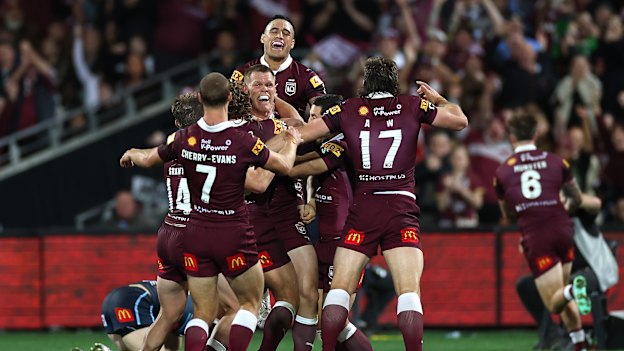 Lindsay Collins and his Maroons teammates celebrate the final try in Adelaide.