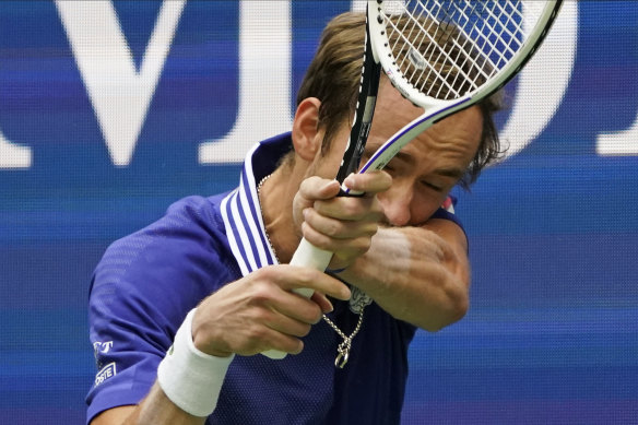 Medvedev returns a shot against Djokiovic.