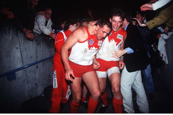 Tony Lockett and Andrew Dunkley celebrate the Swans’ win in the 1996 preliminary final. It might have been the moment everything changed for the Swans.