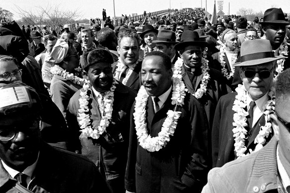 Martin Luther King, Jr, marches across the Edmund Pettus Bridge in Selma, Alabama, on March 21, 1965,