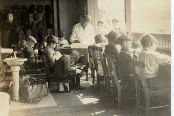 Children working on the verandah in 1930. 