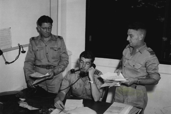 Flt. Lt. P. Lane (Brisbane) equipment officer, Wing Commander J. F. Lush (Melbourne) temporary Commander 90 Wing, and Squadron Leader G. Moodie (Melbourne), senior administration officer, at 90 Wing Headquarters, Malaya. December 5, 1950.