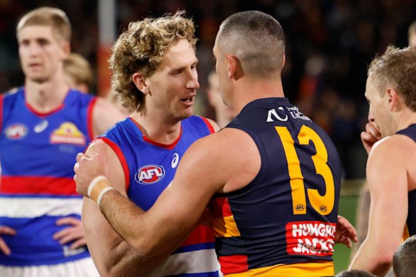 Aaron Naughton congratulates Taylor Walker after the former Crows skipper’s final Adelaide Oval game.
