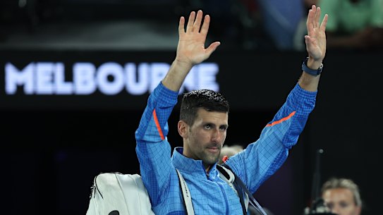Novak Djokovic waves to the crowd after breezing past local hope Alex de Minaur.