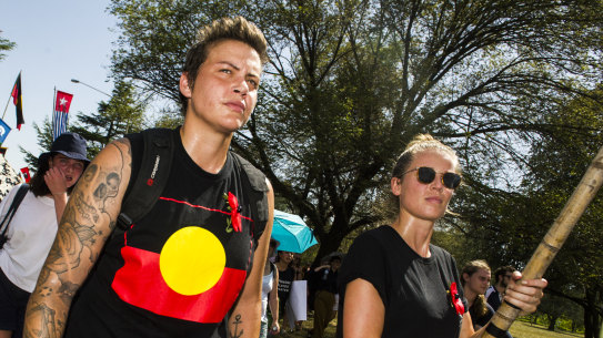 Invasion Day protesters march through Canberra on their way to the Aboriginal Tent Embassy on Saturday morning.