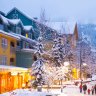 Whistler's world class pedestrian village filled with shops, hotels and restaurants blanketed with fresh snow at dusk Whistler Canada