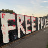 The freshly painted sign conceals a tribute to Israeli hostages erected in the heart of Melbourne’s Jewish community.