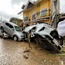 Vehicles lie piled on after flooding caused by Typhoon Kalmaegi in Cebu city, central Philippines, Tuesday, Nov. 4, 2025. (AP Photo/Jacqueline Hernandez)