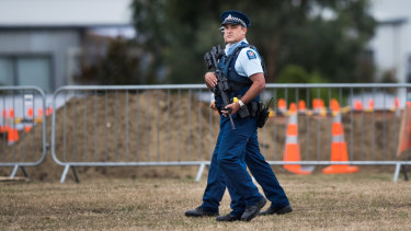 Heavily armed New Zealand Police patrol the Memorial Park Cemetery as 50 graves are being dug for the victims of Friday's attacks.