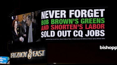 An electronic billboard in the middle of Rockhampton raises the spectre of Julia Gillard and Bob Brown.