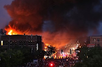 A large fire burns in Minneapolis during a third night of unrest on Thursday, following the death of George Floyd in police custody on Monday.