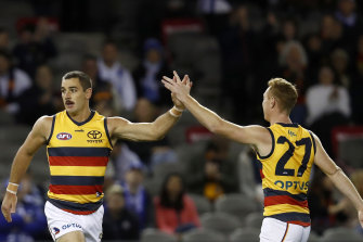 Taylor Walker celebrates a goal with team mate Tom Lynch during the Crows’ clash with North Melbourne.