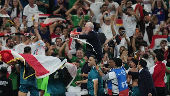 Iraq's coach Graham Arnold celebrates with fans after the World Cup playoff.