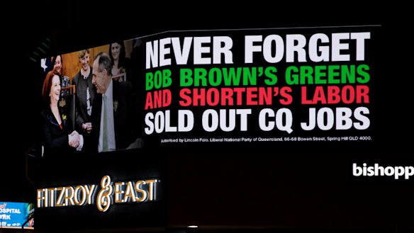 An electronic billboard in the middle of Rockhampton raises the spectre of Julia Gillard and Bob Brown.