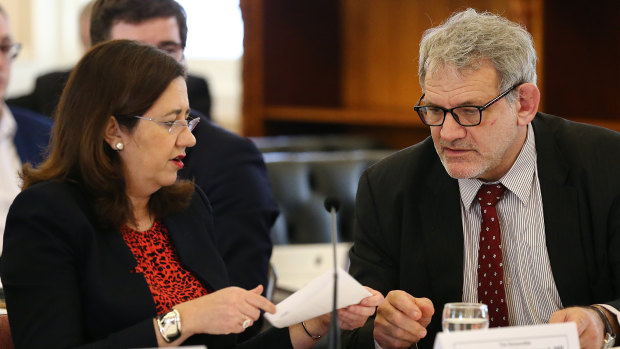 Premier Annastacia Palaszczuk speaks with Chief of staff David Barbagallo during estimate hearings last week. 