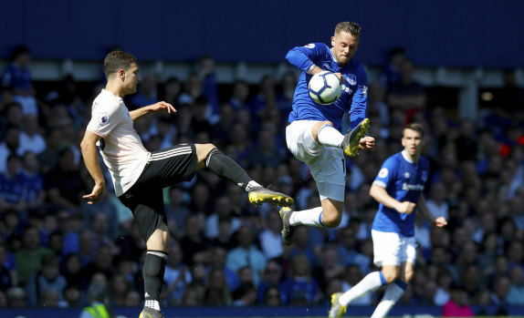 Manchester United's Diogo Dalot challenges and Everton's Gylfi Sigurdsson at Goodison Park on Sunday.