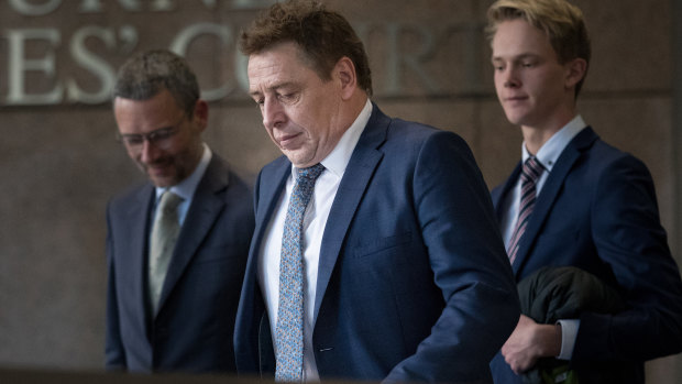 Mark Thompson (centre) leaves court with his lawyer, Peter Matthews (left) in 2019.