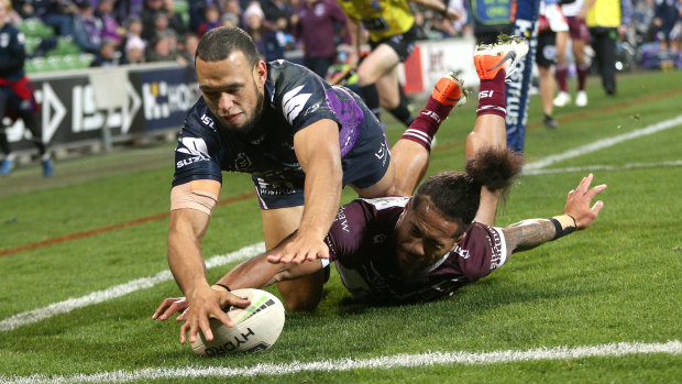 Will Chambers keeps the ball in play before it goes over the dead-ball line to score a try over the top of Manly's Jorge Taufua on Saturday night.