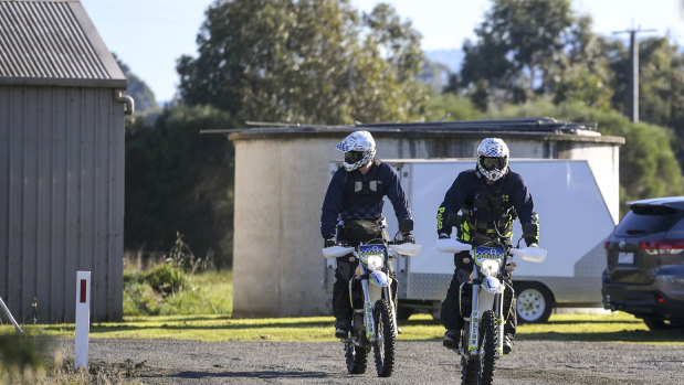 Police on trail bikes search near Labertouche on Monday.
