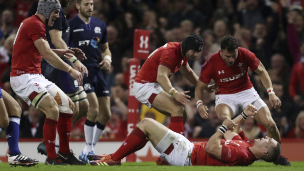 Enter the Dragons: Wales celebrate a try from George North against the Scots.