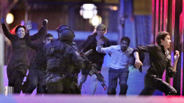 Hostages run from the Lindt Cafe towards Special Operations police on December 16, 2014.