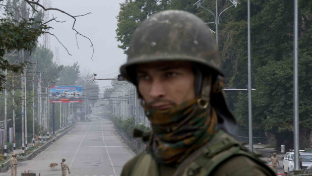 An Indian soldier guards a deserted road  during lockdown in Srinagar, Indian controlled Kashmir, on Thursday.