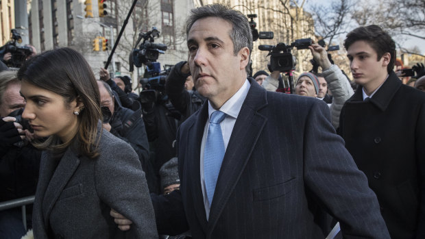 Michael Cohen arrives at court this week flanked by his daughter (left) and son (right).