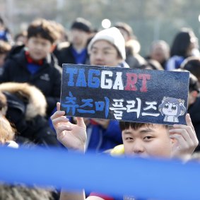 A young Suwon fans holds up a sign dedicated to Adam Taggart.