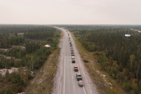 Yellowknife residents leave the city on Thursday using the only highway in or out of the community, after an evacuation order was issued.
