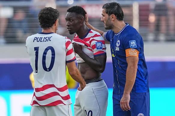 Players commiserate with star US striker Folarin Balogun after he was shown the red card.